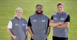 Three adults wearing Bunnings Trade Movember sleeveless hoodies